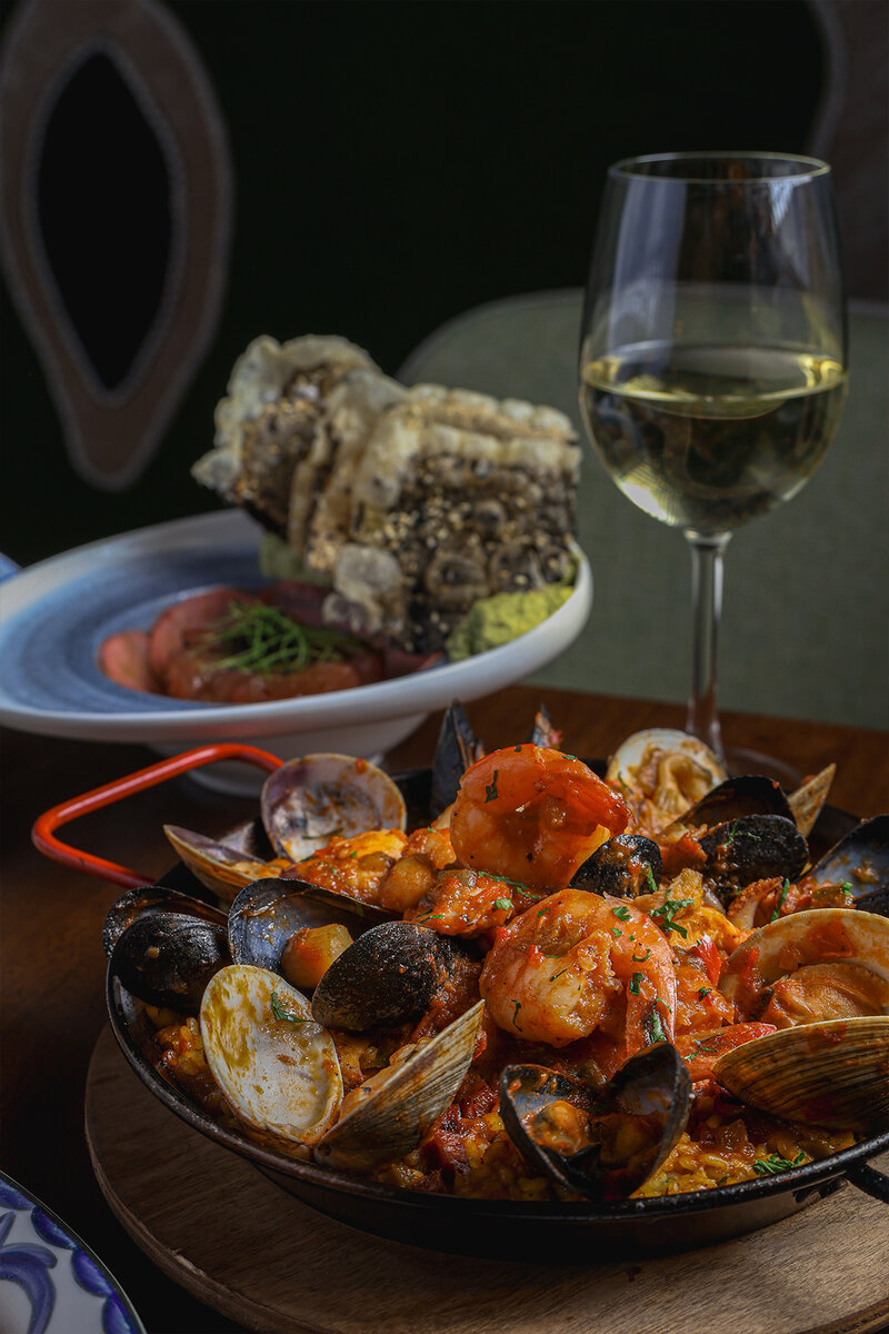 Jambalaya style paella with glass of white wine