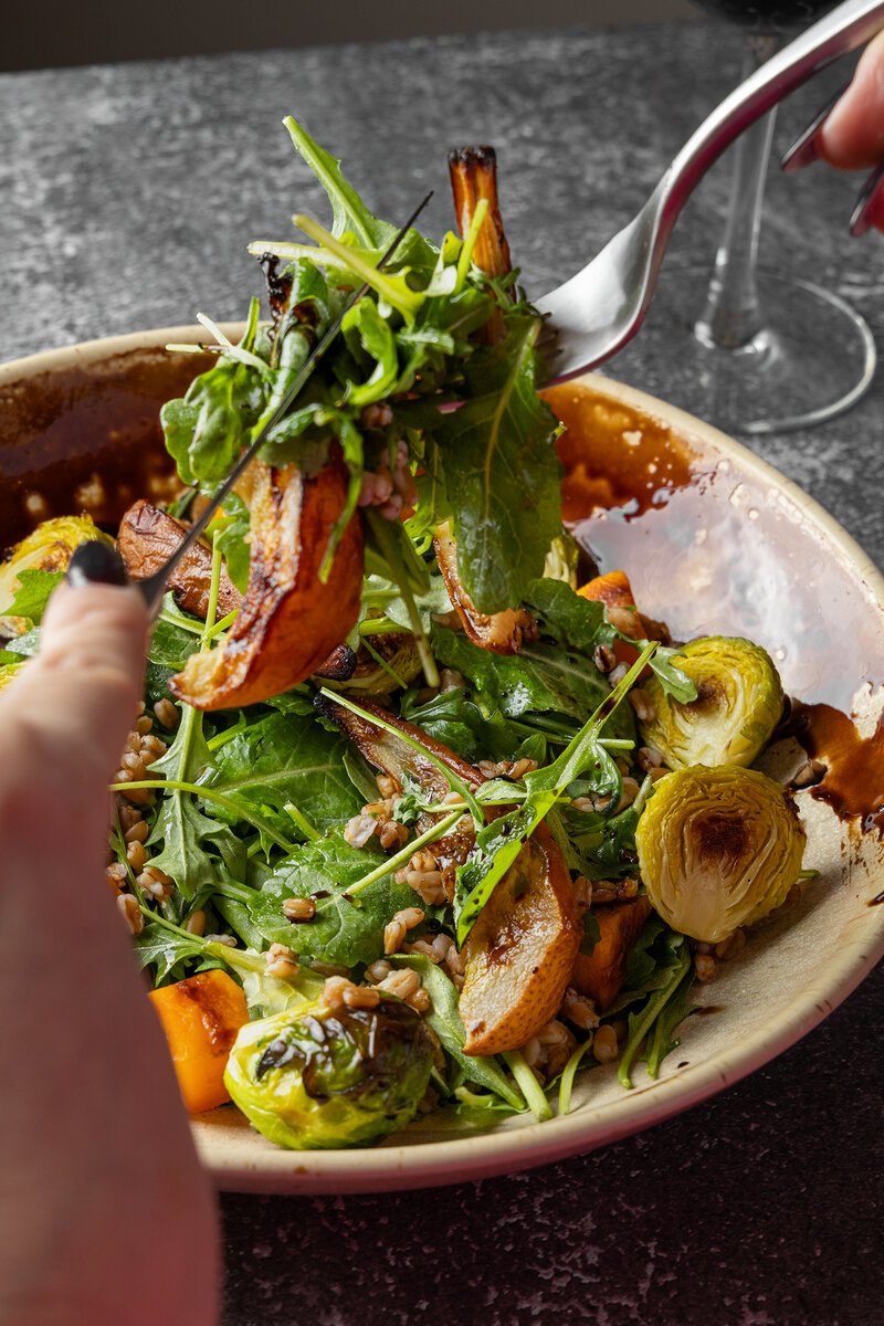 Guest eating farro, brussels and pear salad