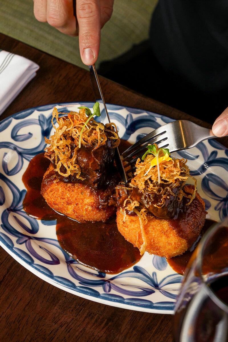 Fried dumplings topped with frizzled onions